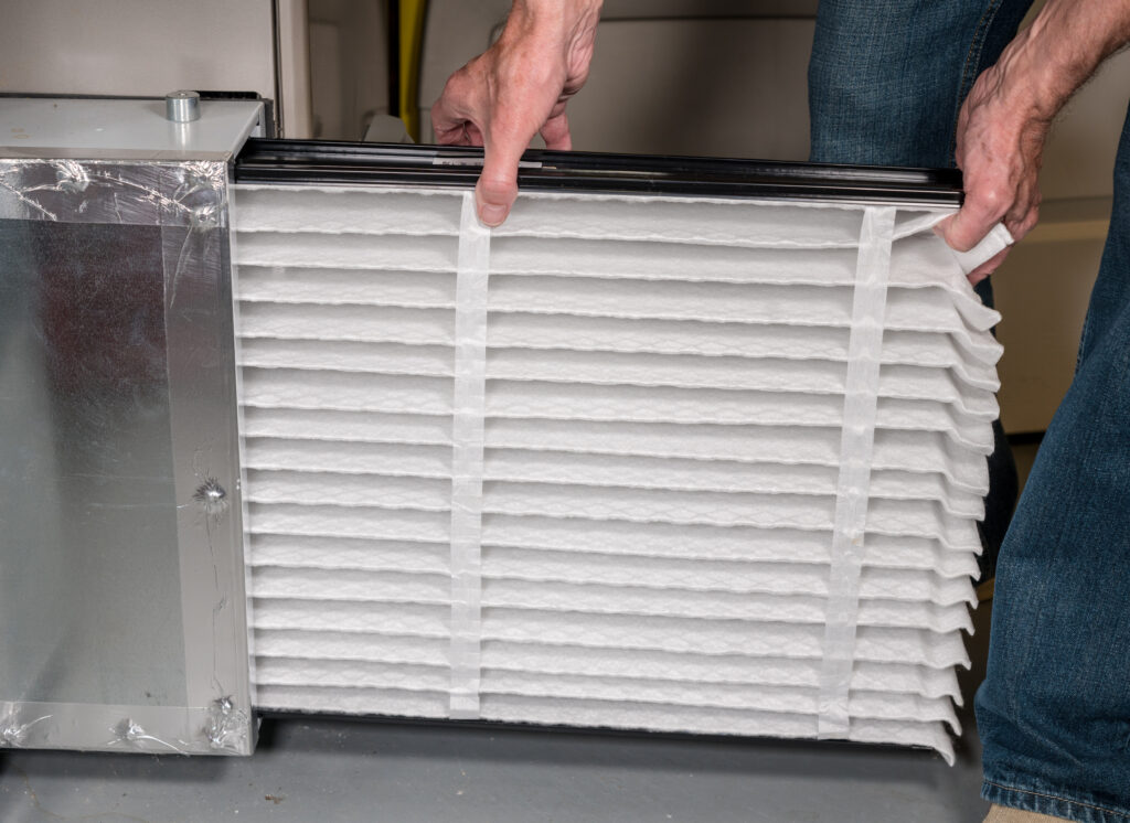 Closeup of hand changing air filter.